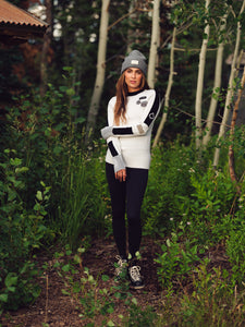 Ajax Sandy Sweater Women's in White Lifestyle Photo in Aspen Trees Female Model with Grey Beanie Cap